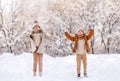 Happy little kids brother and sister rejoicing first snow in snowy winter park Royalty Free Stock Photo