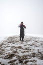 Wintertime: time to have fun in a ski resort. Snow, mountaintop, haziness, skier.