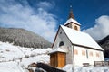A wintertime view of a small church with a tall steeple Royalty Free Stock Photo