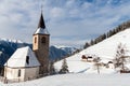 A wintertime view of a small church with a tall steeple Royalty Free Stock Photo