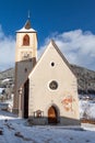 A wintertime view of a small church with a tall steeple Royalty Free Stock Photo