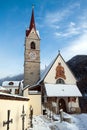 A wintertime view of a small church with a tall steeple Royalty Free Stock Photo