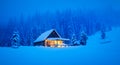 A wintery scene in the heart of the woods with a solitary wooden cottage Royalty Free Stock Photo