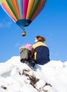 Mother and daugter enjoying the sight of hot air balloons taking off