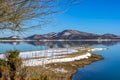 Wintry, landscape. Black snowy mountain, clear sky on lake Plastira at a winter day, Greece. Royalty Free Stock Photo
