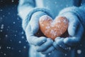 Wintry love symbol: Female hands, gloves, snowy heart, Valentines concept