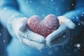 Wintry love symbol: Female hands, gloves, snowy heart, Valentines concept