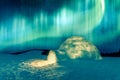 Wintry scene with glowing polar lights and snowy igloo Royalty Free Stock Photo