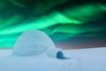 Wintry scene with glowing polar lights and snowy igloo Royalty Free Stock Photo