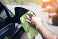 wipes a wet car with a rag Royalty Free Stock Photo