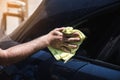 wipes a wet car with a rag Royalty Free Stock Photo