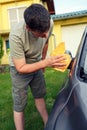 Wiping car- male cleaning car with microfiber cloth, car detailing. Royalty Free Stock Photo