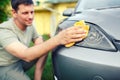 Wiping car- Smiling male cleaning car with microfiber cloth, car Royalty Free Stock Photo