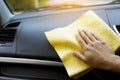 Wiping the car with a yellow microfiber cloth by hands. Royalty Free Stock Photo