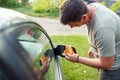 Wiping car- man cleaning car with microfiber cloth, car detailing. Royalty Free Stock Photo