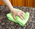 Wiping down Kitchen Stone Countertop Royalty Free Stock Photo