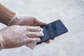 Wiping smartphone screen with gloves on Royalty Free Stock Photo