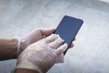 Wiping smartphone screen with gloves on Royalty Free Stock Photo