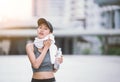 Wiping sweat Thirsty female jogger drinking fresh water Royalty Free Stock Photo