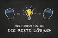 `Wir finden fÃÂ¼r Sie die beste LÃÂ¶sung`, heads and idea bulb with chalk board background. Translation: `We find for you the bes Royalty Free Stock Photo