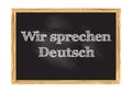 Wir sprechen Deutsch - We speak German in German blackboard notice Vector illustration Royalty Free Stock Photo
