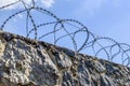 Sky and barbed wire on a stone fence Royalty Free Stock Photo