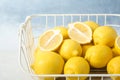Wire basket with lemons on table Royalty Free Stock Photo