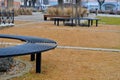 wire circular benches park furniture in winter. sintered gravel with