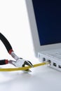 Wire Cutters Cutting Cable to Laptop Royalty Free Stock Photo