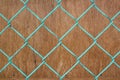 Wire fence on brown wood background Royalty Free Stock Photo