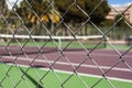 Wire fence at empty tennis court