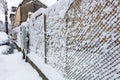 Wire fence metallic net with snow. Metal net in winter covered with snow Royalty Free Stock Photo