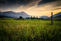 A wire fence on a working ranch at sunset Royalty Free Stock Photo