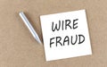 WIRE FRAUD text on sticky note on a cork board with pencil Royalty Free Stock Photo