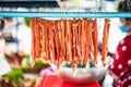 Wire-hung marinated meat for sale on carts for selling papaya salad i