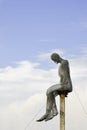 Wire man statue art sitting blue day cloud