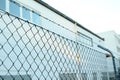 Wire mesh, barbed wire fence on top, concept prison, security zone, close-up, copy space Royalty Free Stock Photo