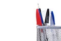 Wire mesh desk tidy with pens and a ruler