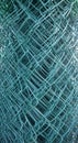 Wire mesh fence, green, rolled up. Close up, texture, background,