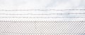 Wire mesh fence made of steel with cloudy sky background. Close up view with details, banner. Royalty Free Stock Photo