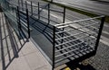Wire mesh metal ramp for wheelchairs, cyclists and mothers with prams. wooden planks and metal lattice fill the railing. gray, run