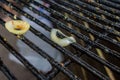 Wire rack on fireplace after picnic cooking. Close up image of kitchen utensils. Greasy metal ribs and two slices of onion after Royalty Free Stock Photo