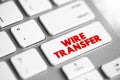Wire transfer - method of electronic funds transfer from one person or entity to another, text button on keyboard Royalty Free Stock Photo
