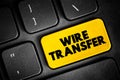 Wire transfer - method of electronic funds transfer from one person or entity to another, text button on keyboard Royalty Free Stock Photo