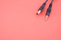 Wire with a USB end and audio cable on a red background Royalty Free Stock Photo