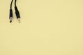 Wire with a USB end and audio cable on a yellow background Royalty Free Stock Photo