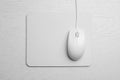 Wired computer mouse and pad on white background, flat lay. Space for text