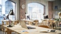 Wired Laptop on a Desk in a Bright Spacious Empty Workplace. Office Supplies Are on the Table. Big Royalty Free Stock Photo