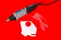 Wired Mini Drill, Safety Glasses and Dust Mask Isolated on Red Royalty Free Stock Photo