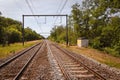 wired railway landscape tracks perspective sunny day in the countryside blue sky green trees Royalty Free Stock Photo